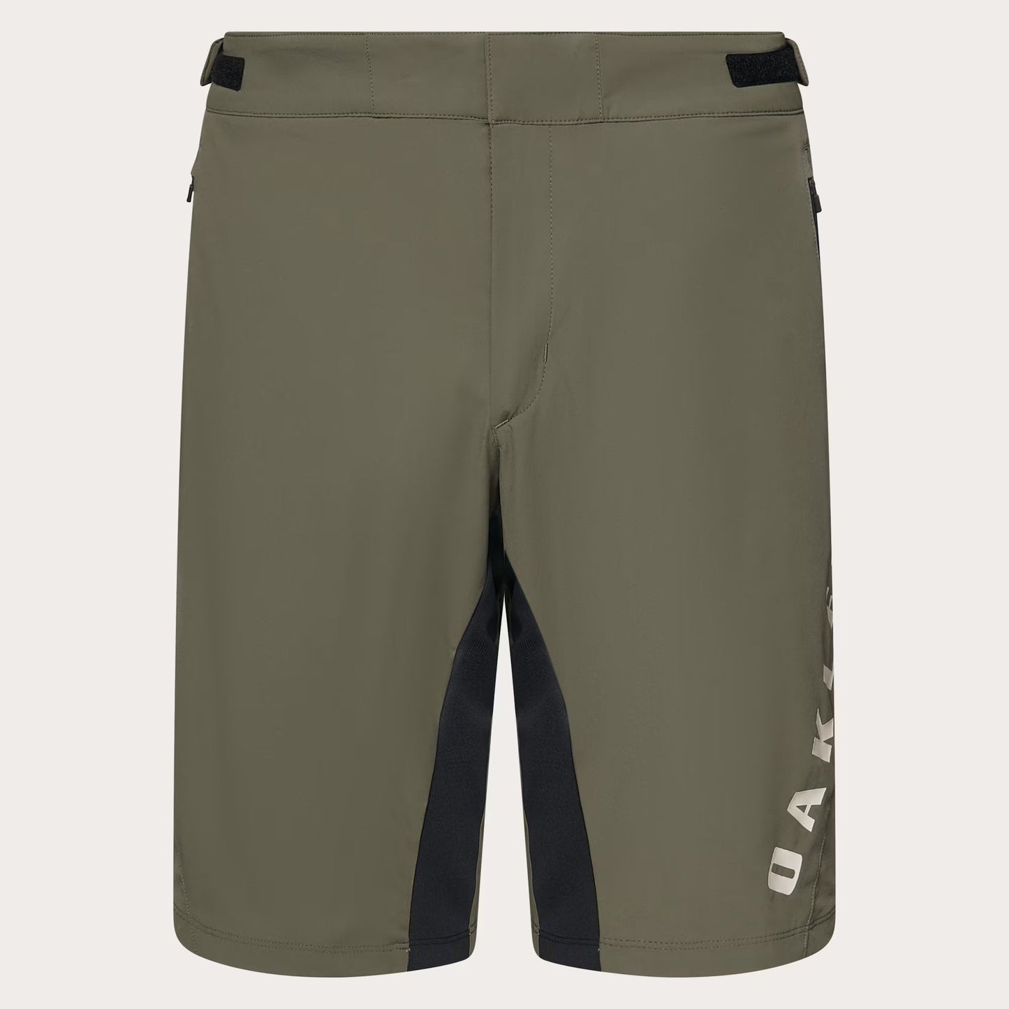 Olive green Oakley shorts with black side paneling and a white vertical Oakley logo on the lower right leg, shown against a light off-white background.