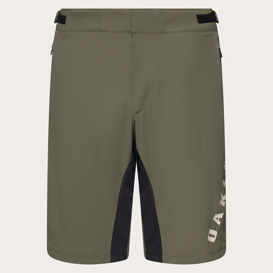 Olive green Oakley shorts with black side paneling and a white vertical Oakley logo on the lower right leg, shown against a light off-white background.