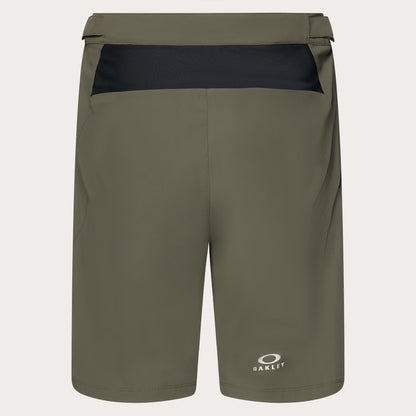 Olive green Oakley athletic shorts with a black contrast waistband panel and a small white Oakley logo near the lower left leg, shown on a light gray background.