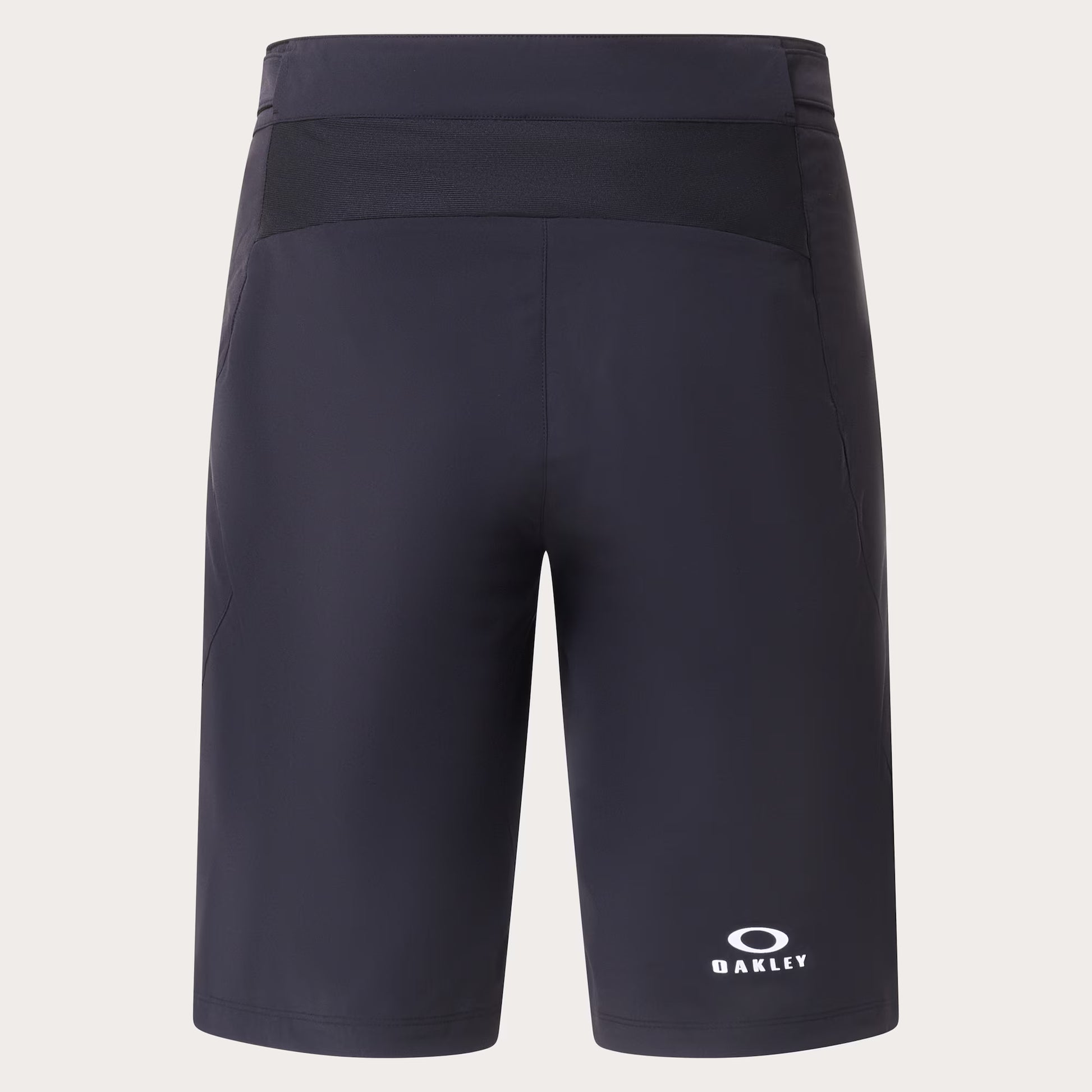 Dark navy athletic shorts with a white Oakley logo on the lower left leg, shown against a light beige background.