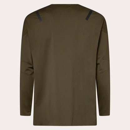An olive green long-sleeve athletic top shown from the back, featuring two dark navy hook-and-loop strap details at the top of the shoulders, displayed on a light off-white background.