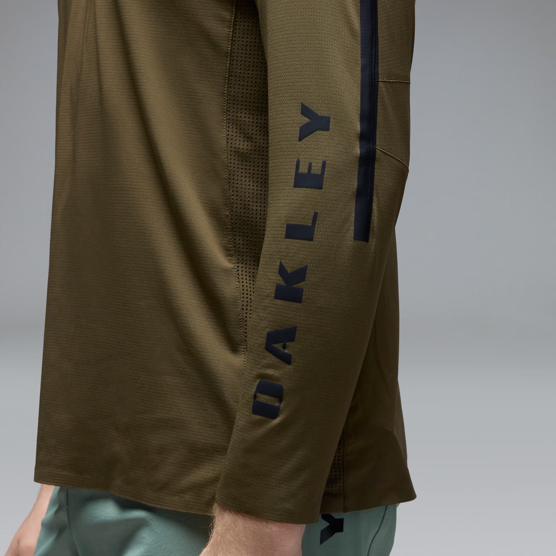 Brown shorts with 'Oakley' branding on a gray background