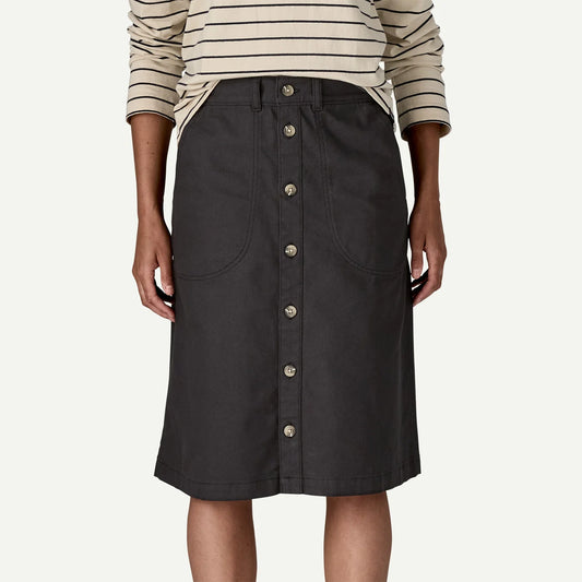 Black button-up skirt worn by a person on a white background