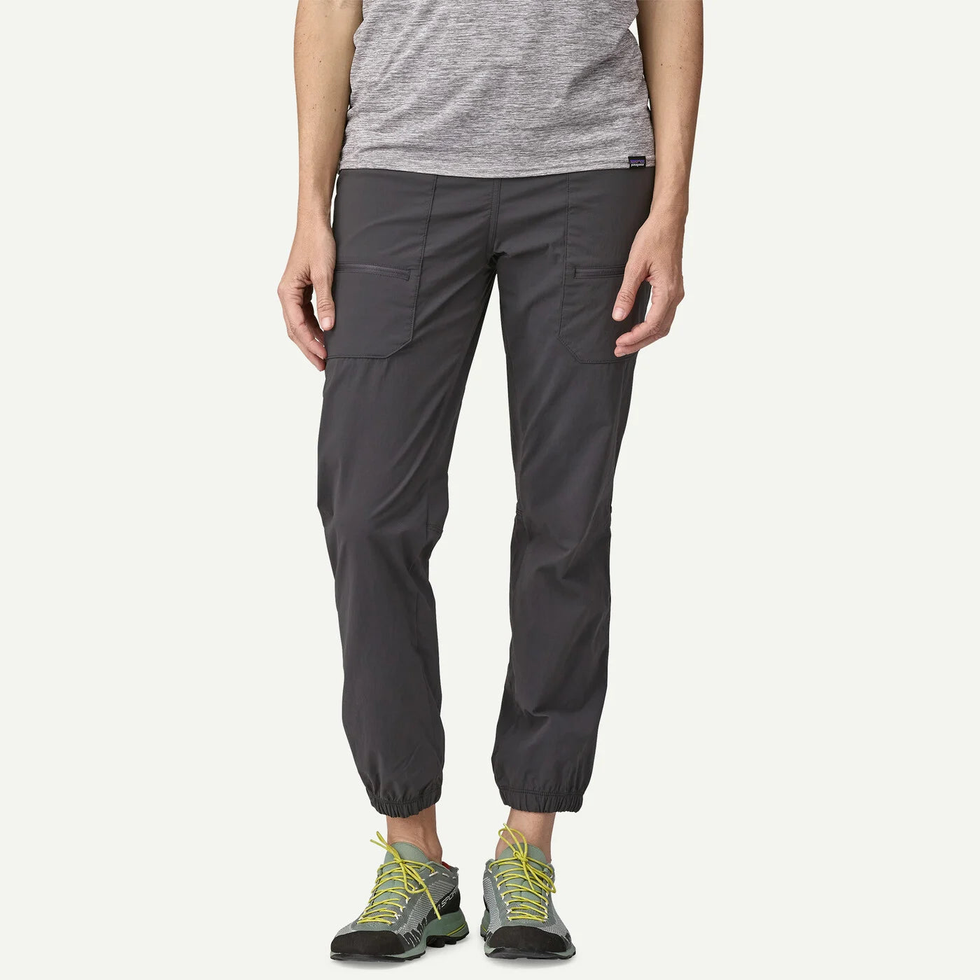 Person wearing dark gray cargo pants on a white background