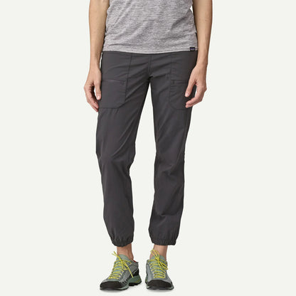 Person wearing dark gray cargo pants on a white background