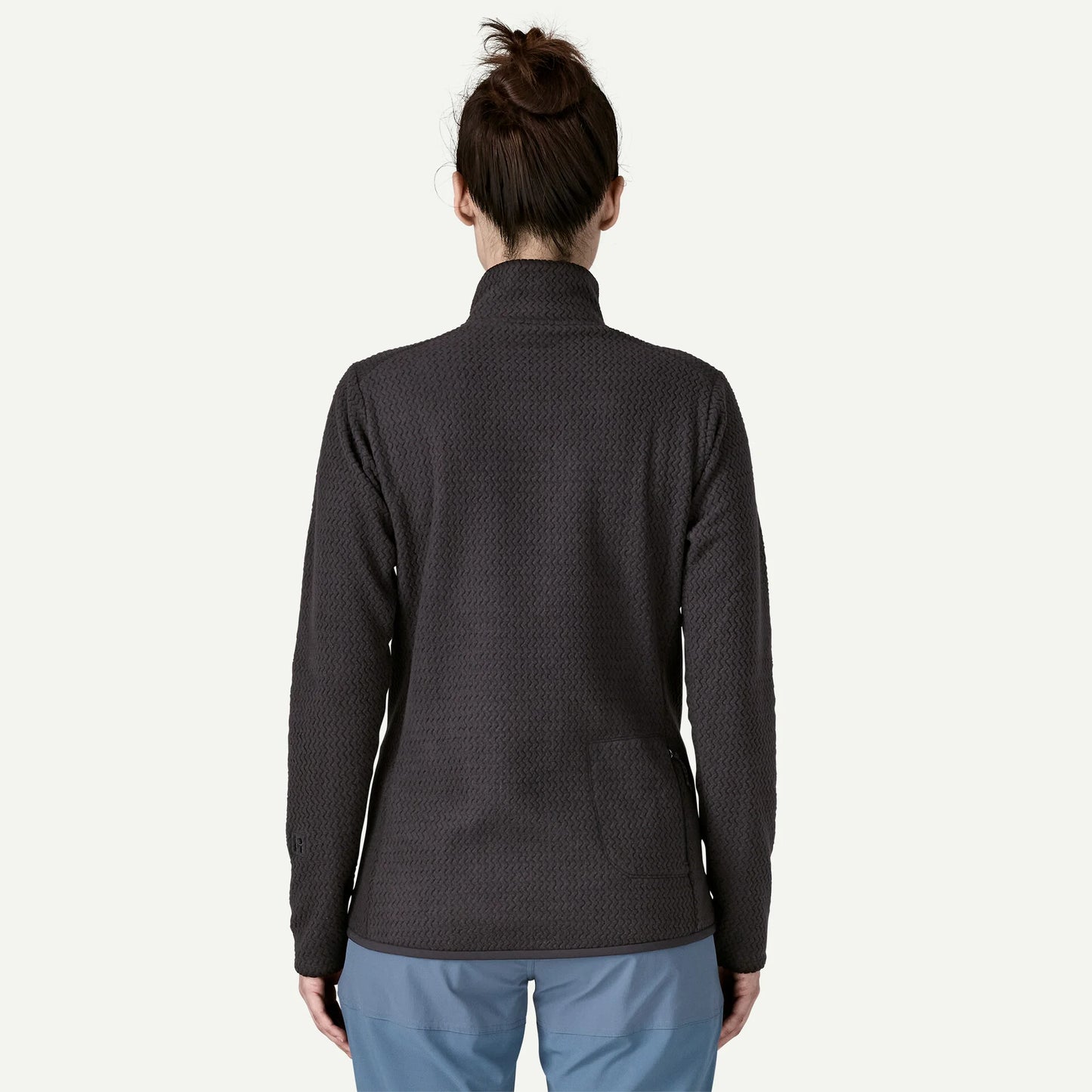 Person wearing a dark gray textured jacket on a white background