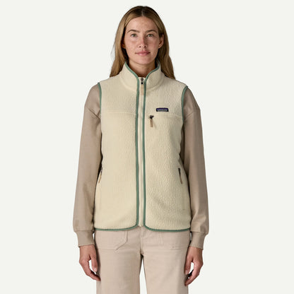 Woman wearing a beige fleece vest with a visible brand logo on a white background