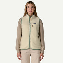 Load image into Gallery viewer, Woman wearing a beige fleece vest with a visible brand logo on a white background
