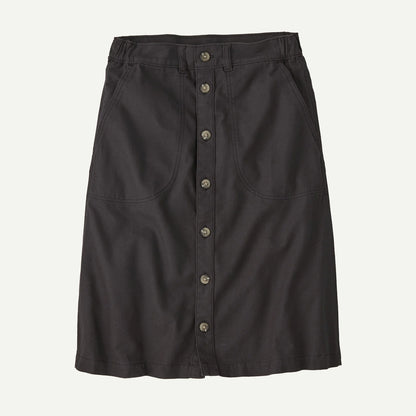 Black skirt with button details on a light gray background