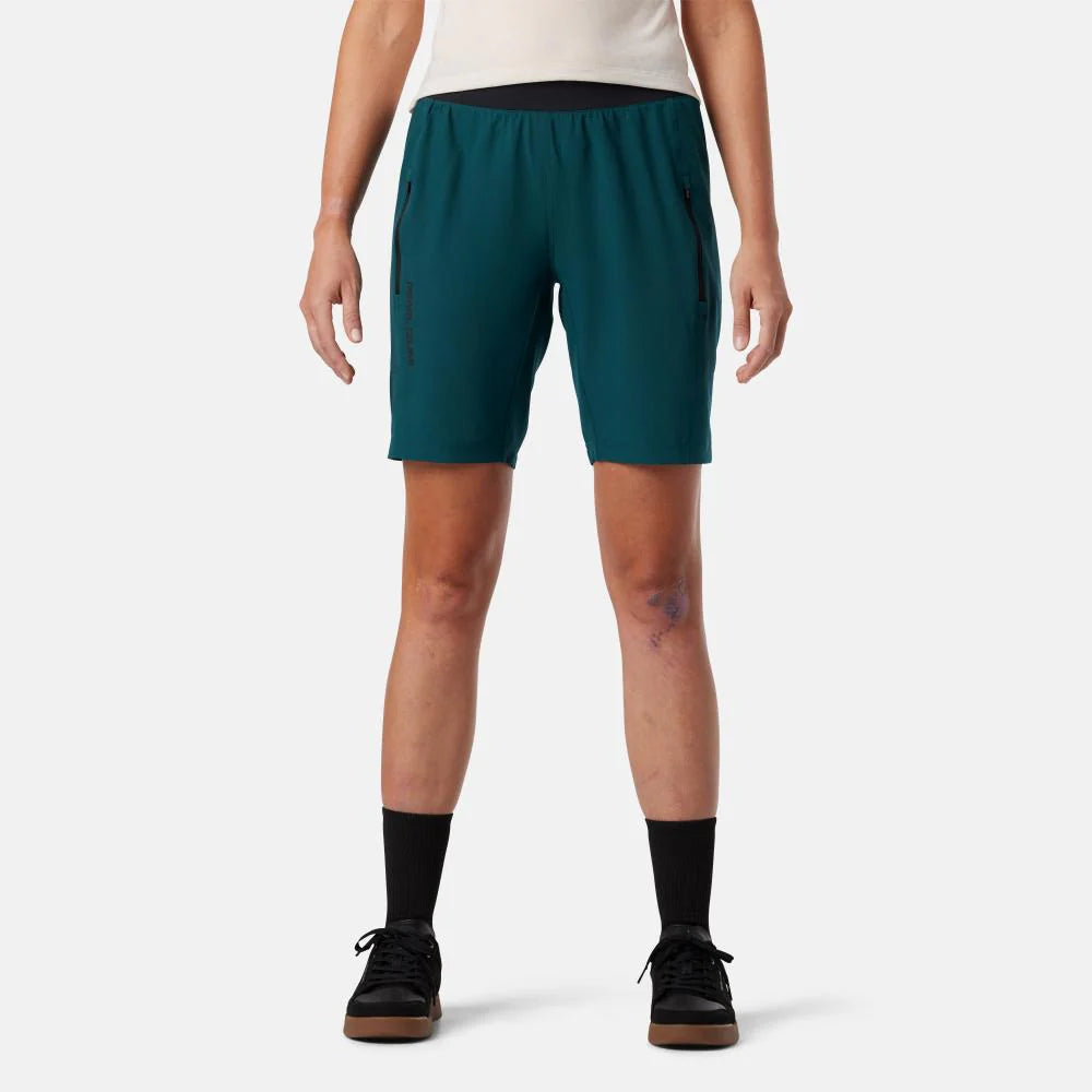 Person wearing teal shorts on a white background
