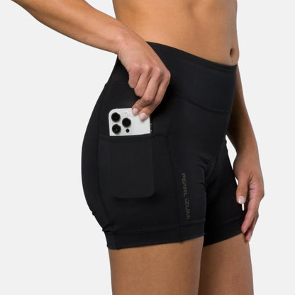 Black athletic shorts with a pocket holding a phone on a white background