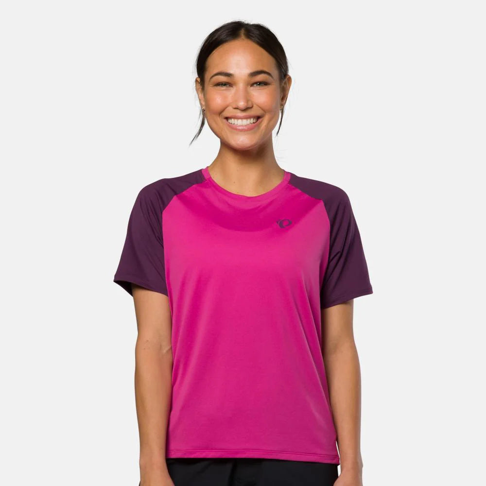 Woman wearing a pink and purple athletic shirt on a white background