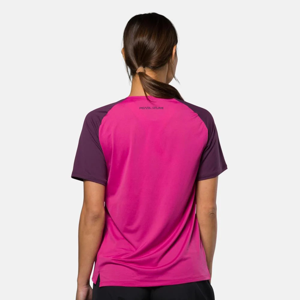 Person wearing a pink and purple athletic shirt on a white background
