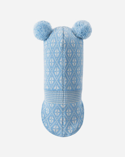 Blue knitted dog toy with pom-poms on a white background