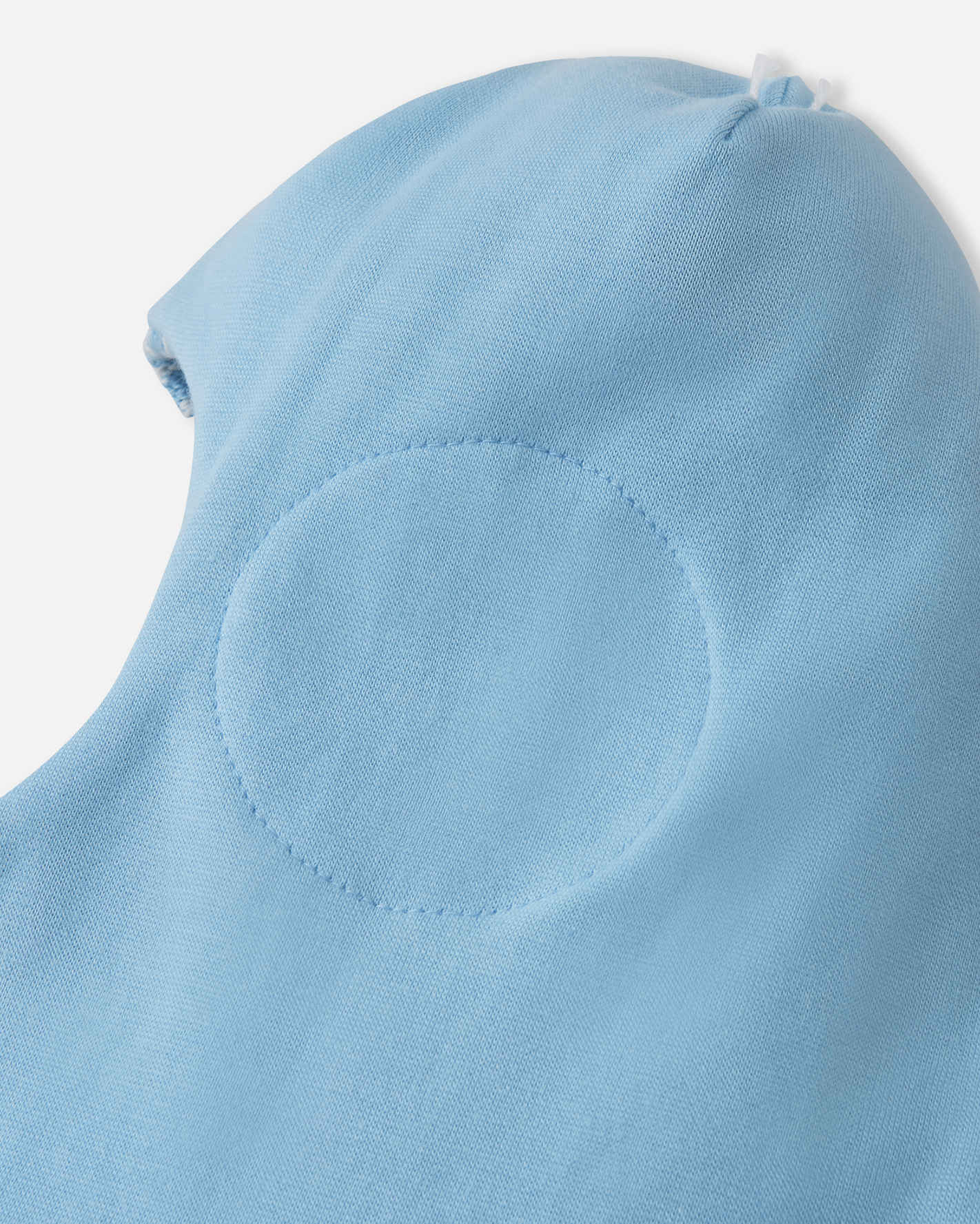 Close-up of a light blue hooded garment on a white background