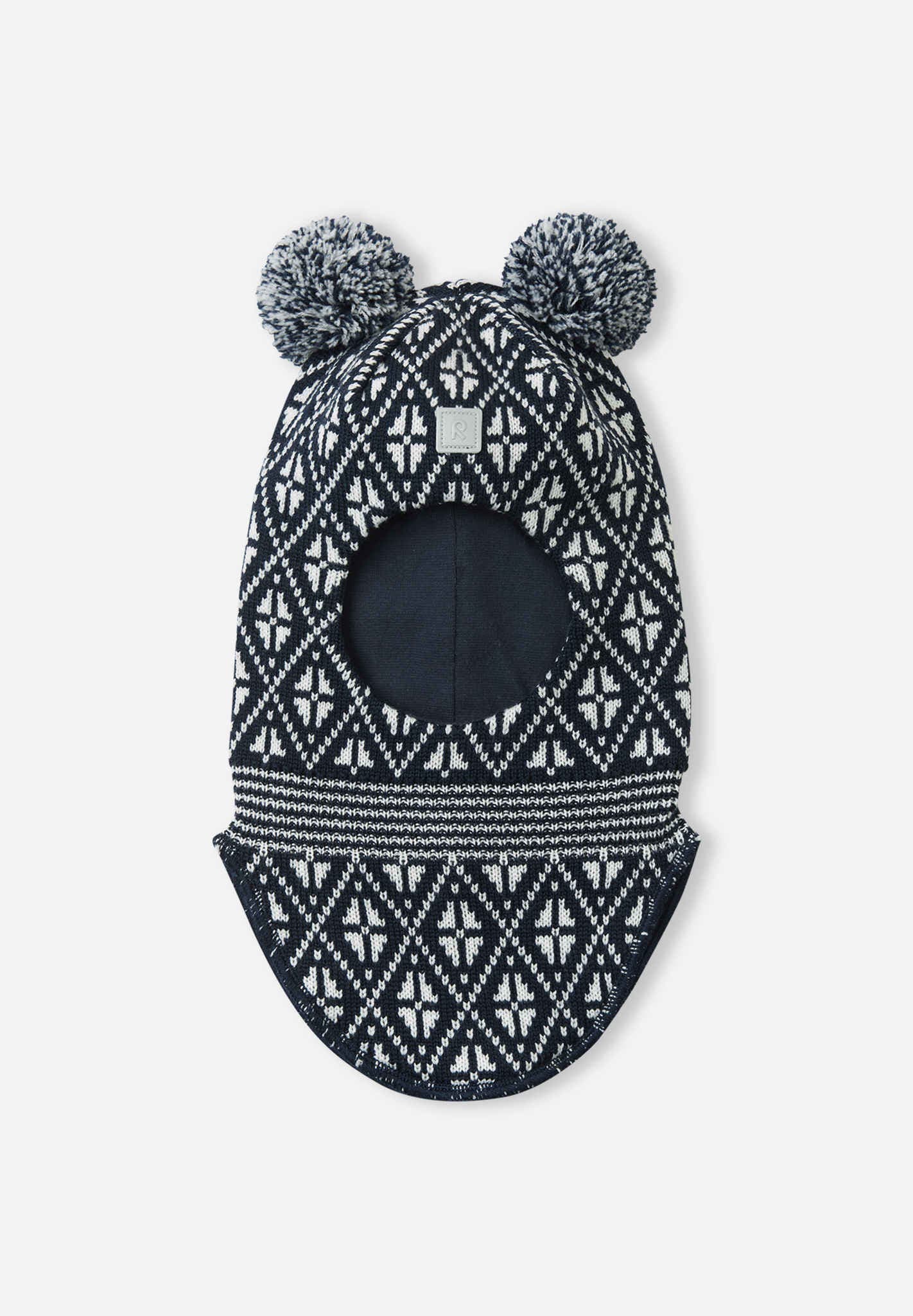 Black and white patterned baby hat with pom-poms on a white background