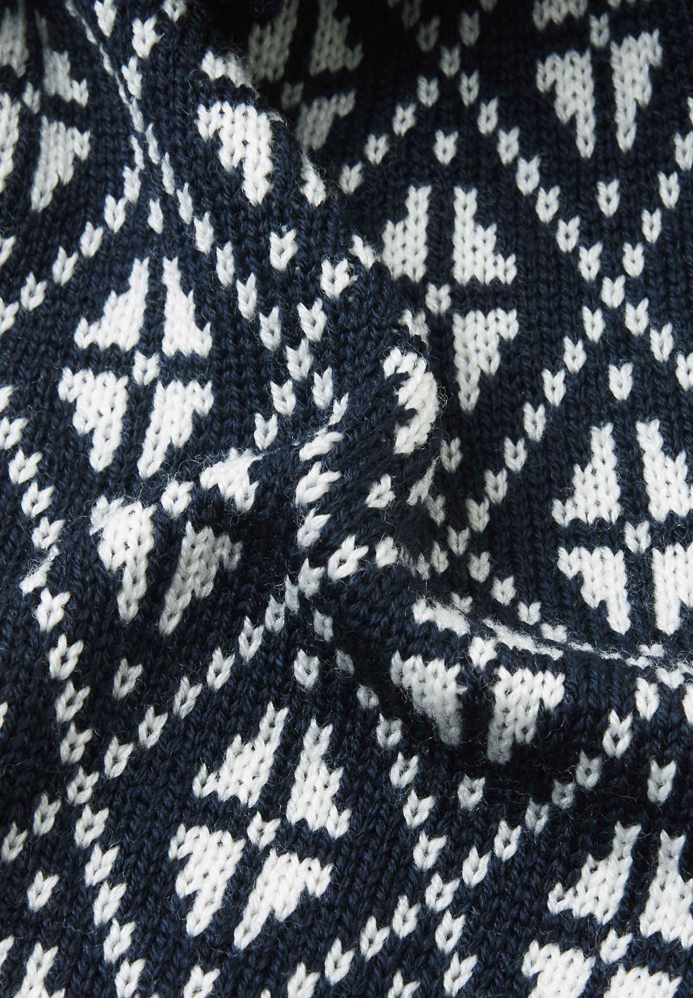 Close-up of a navy blue fabric with white geometric pattern