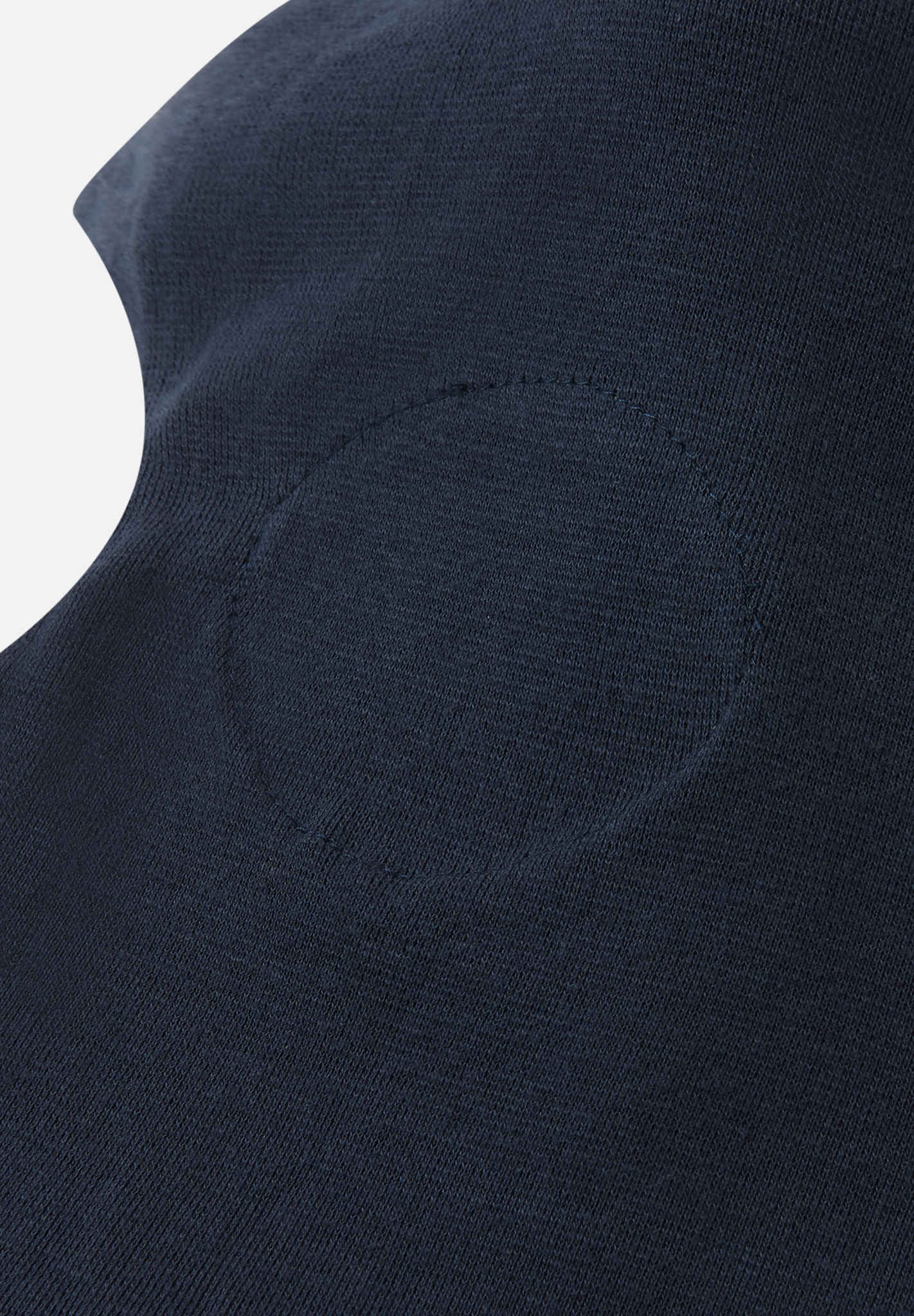 Close-up of a dark blue garment with a pocket detail on a light gray background