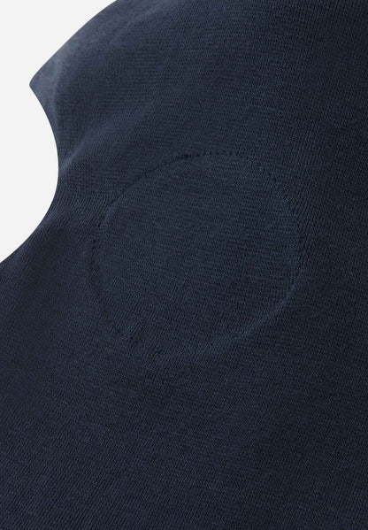 Close-up of a dark blue garment with a pocket detail on a light gray background