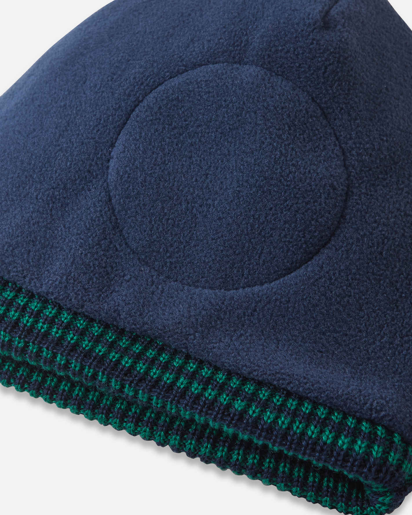 Navy blue beanie with green trim on a white background