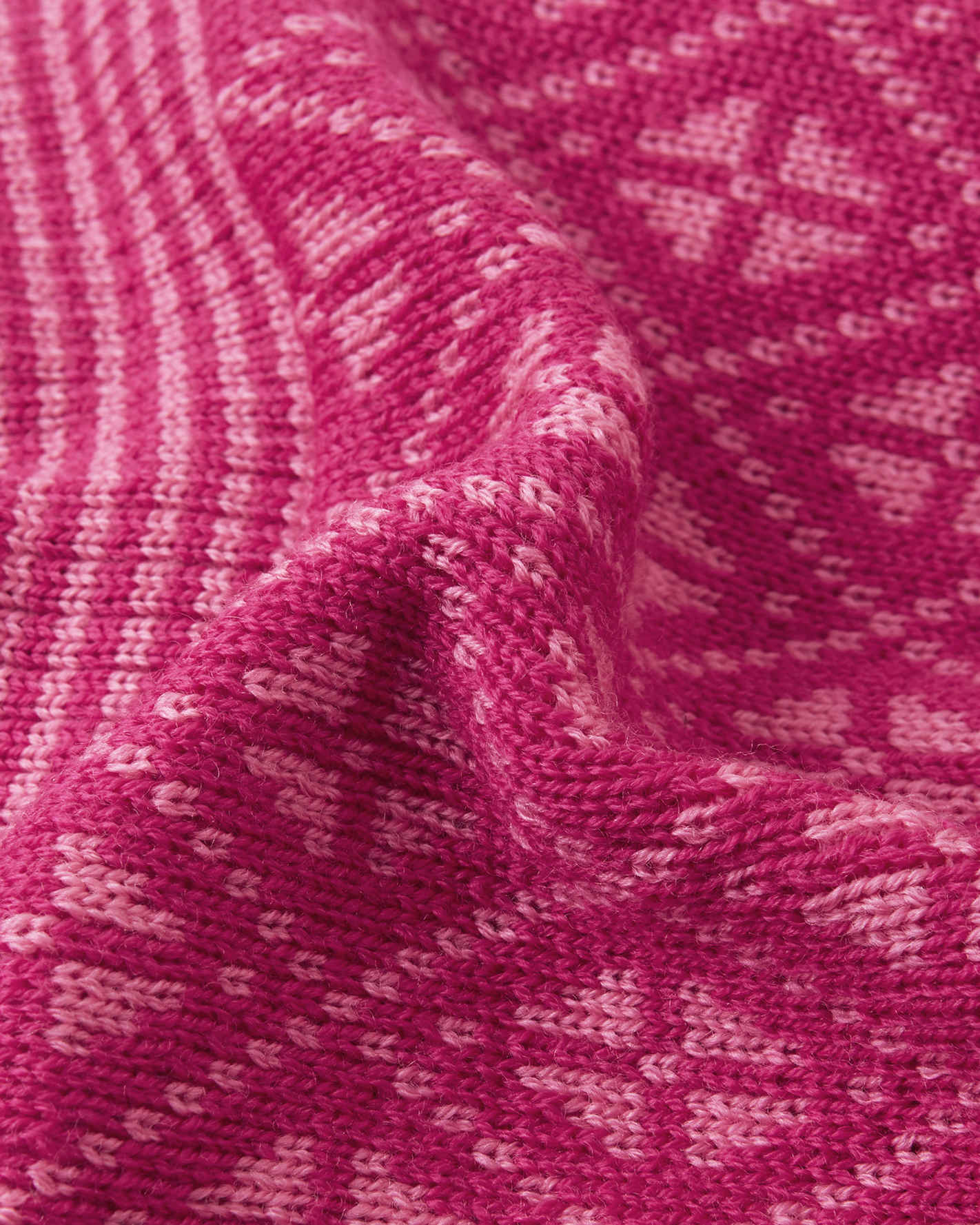 Close-up of pink fabric with a subtle pattern