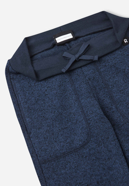 Close-up of a blue textured fabric garment on a white background