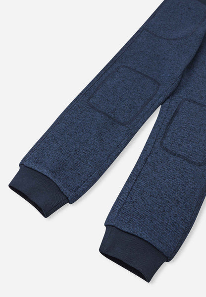 Blue fleece pants with patch pockets on a light gray background