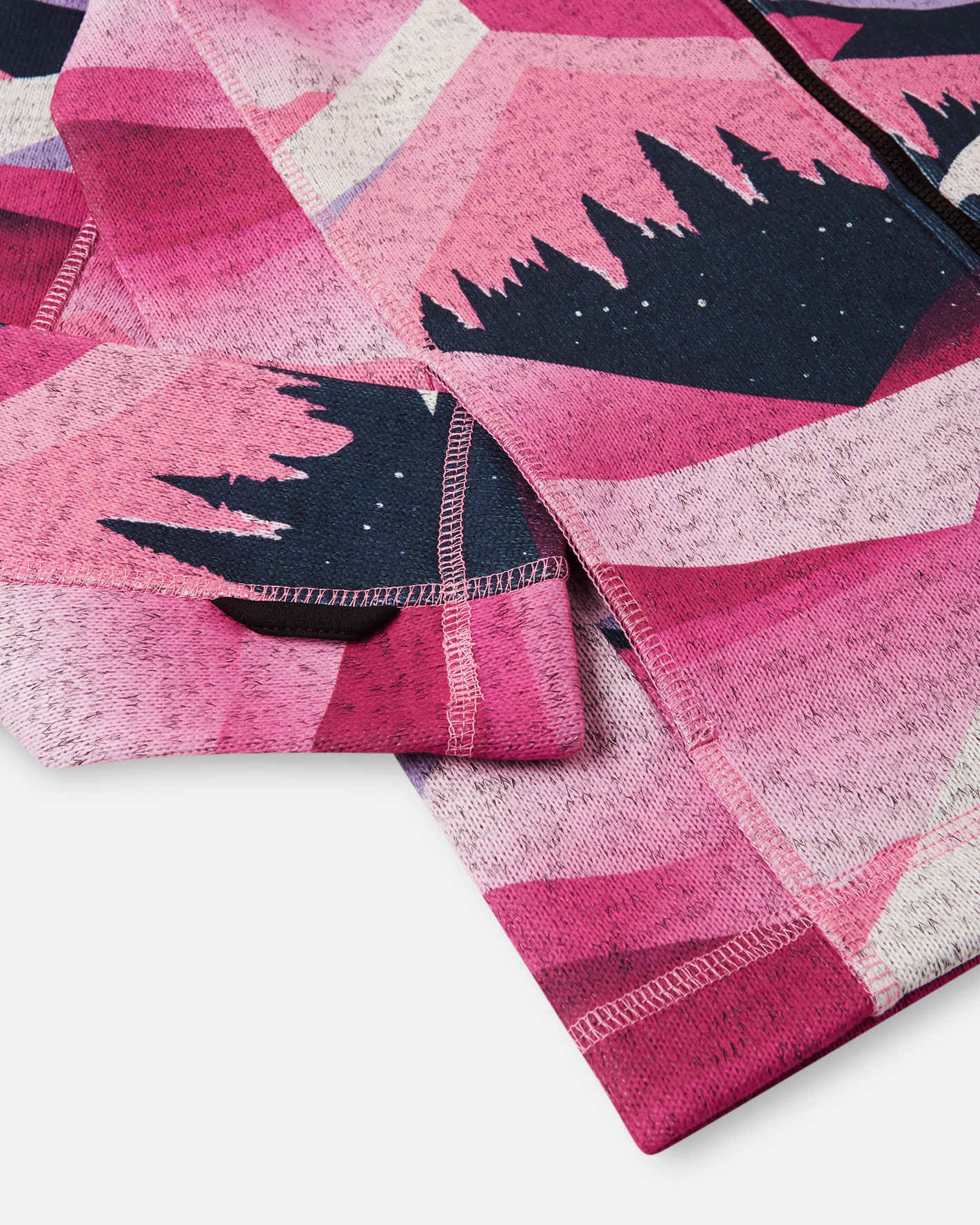 Pink fabric with black geometric patterns on a white background