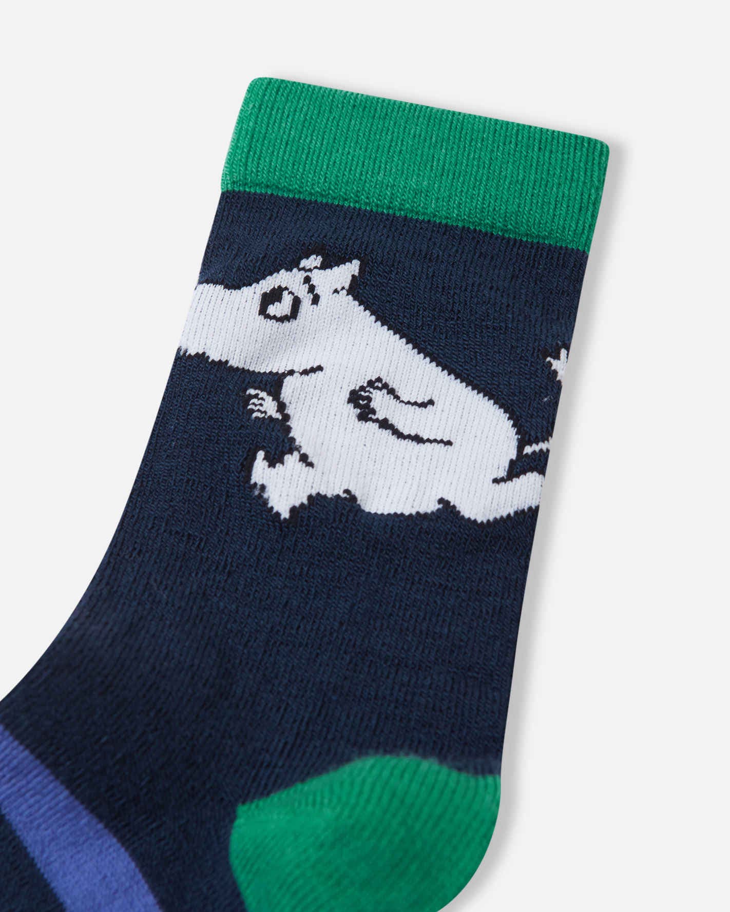 Navy blue sock with a white dog design and green cuff and toe on a light gray background