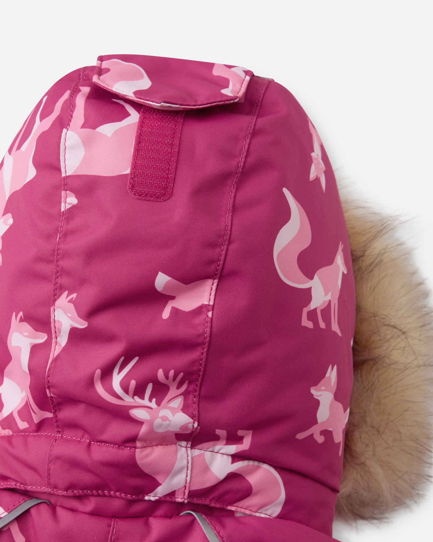 Pink children's snowsuit with animal patterns on a white background