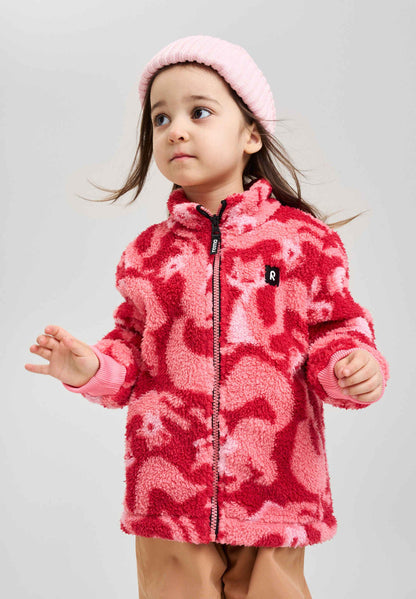 Child wearing a pink fleece jacket with animal pattern on a gray background