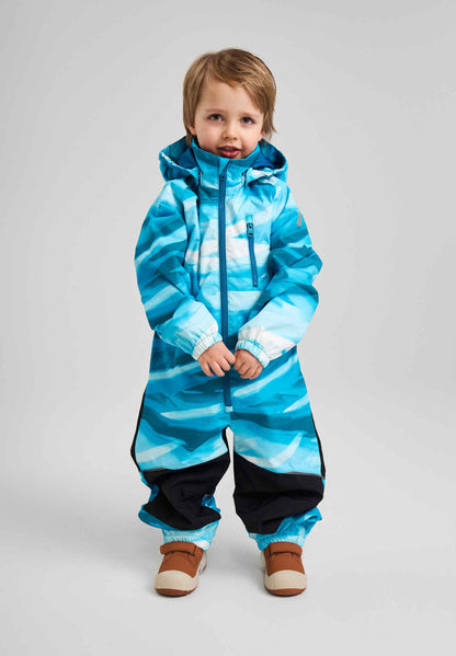 Child wearing a blue and black striped snowsuit on a gray background