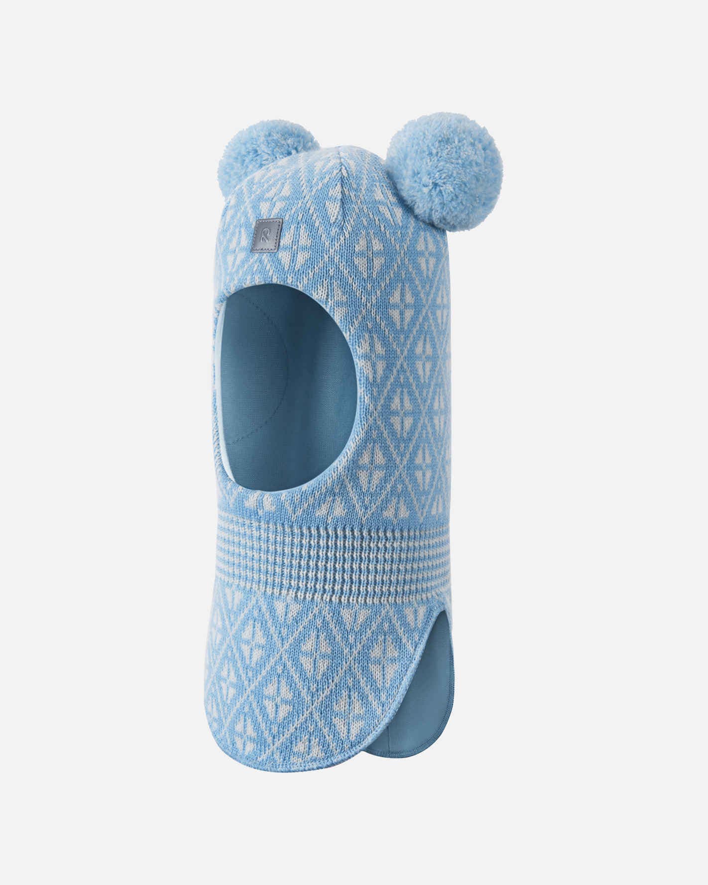 Blue knitted slipper with pom-poms on a white background