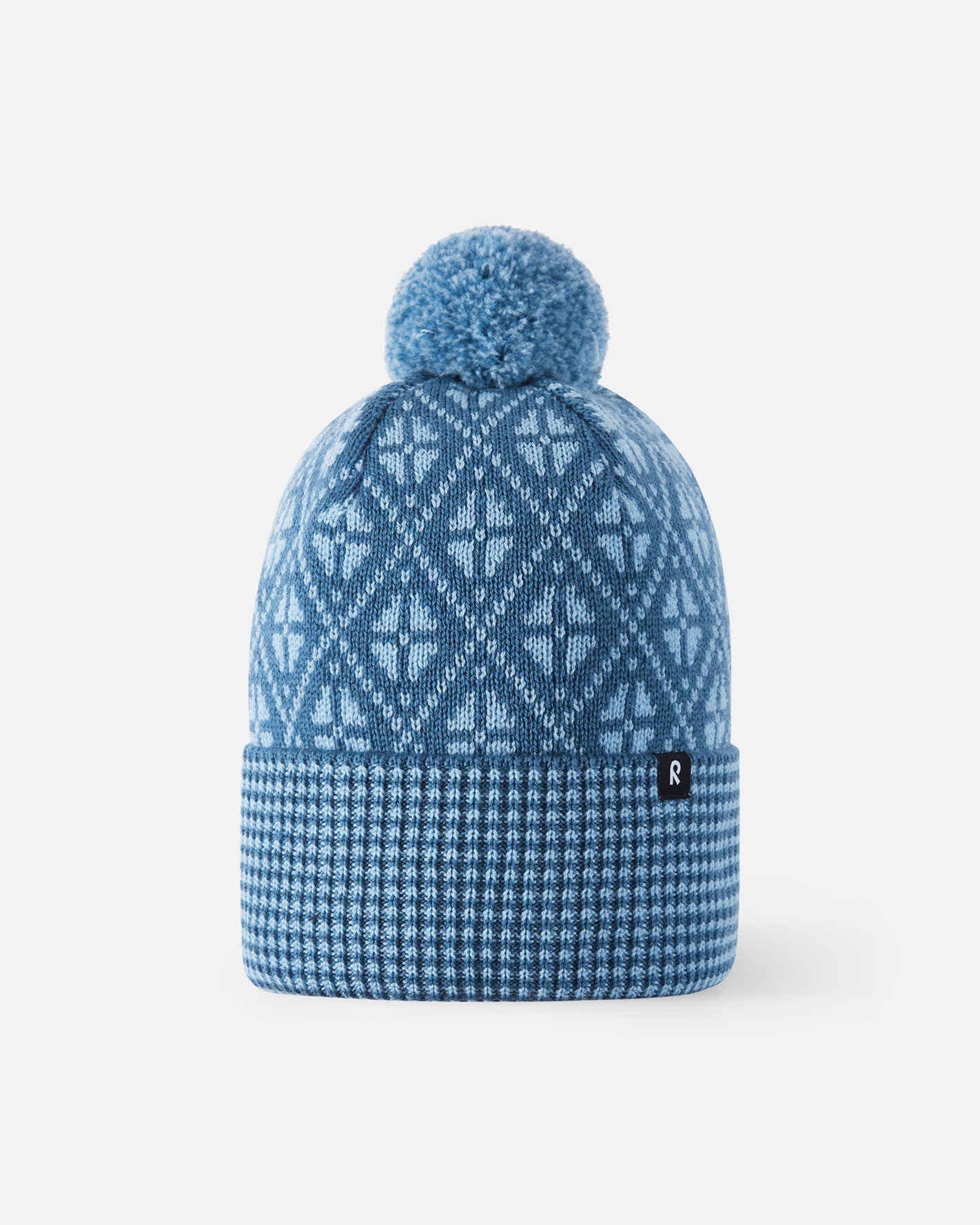 Blue knit beanie with a pom-pom on a white background