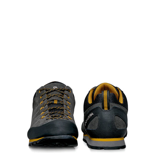 Pair of black and yellow athletic shoes on a white background