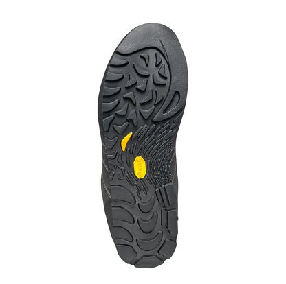 Close-up of a black shoe sole with a yellow logo on a white background