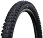 Close-up of a black bicycle tire with purple accents on a white background