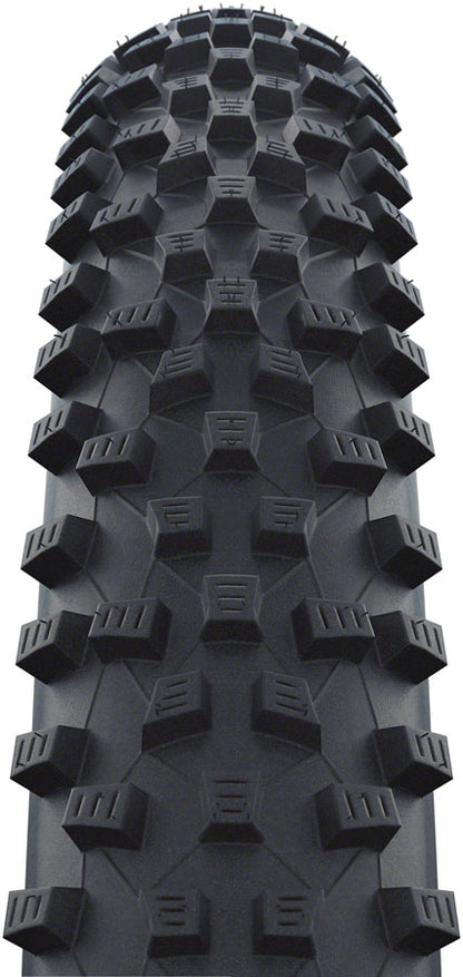 Close-up of a black off-road tire tread pattern on a white background
