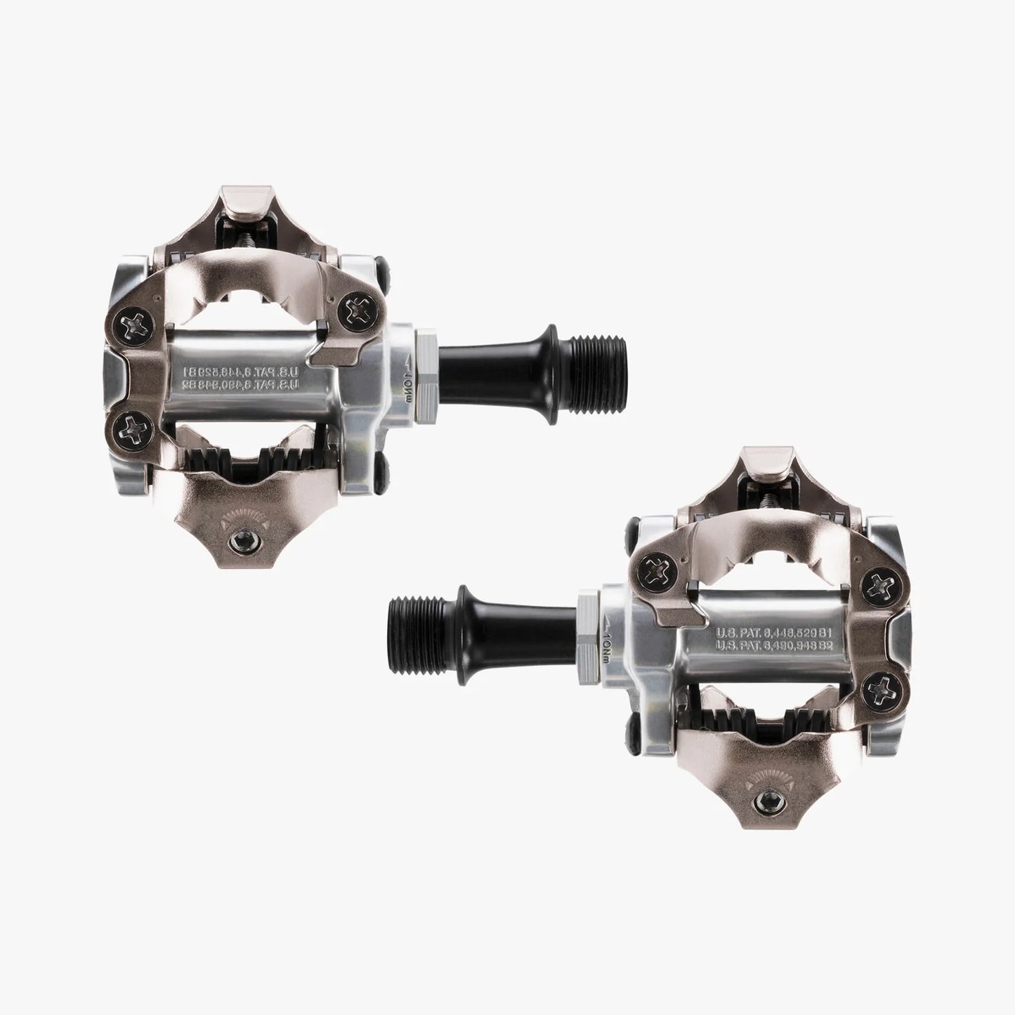 Pair of metallic bicycle pedals on a white background