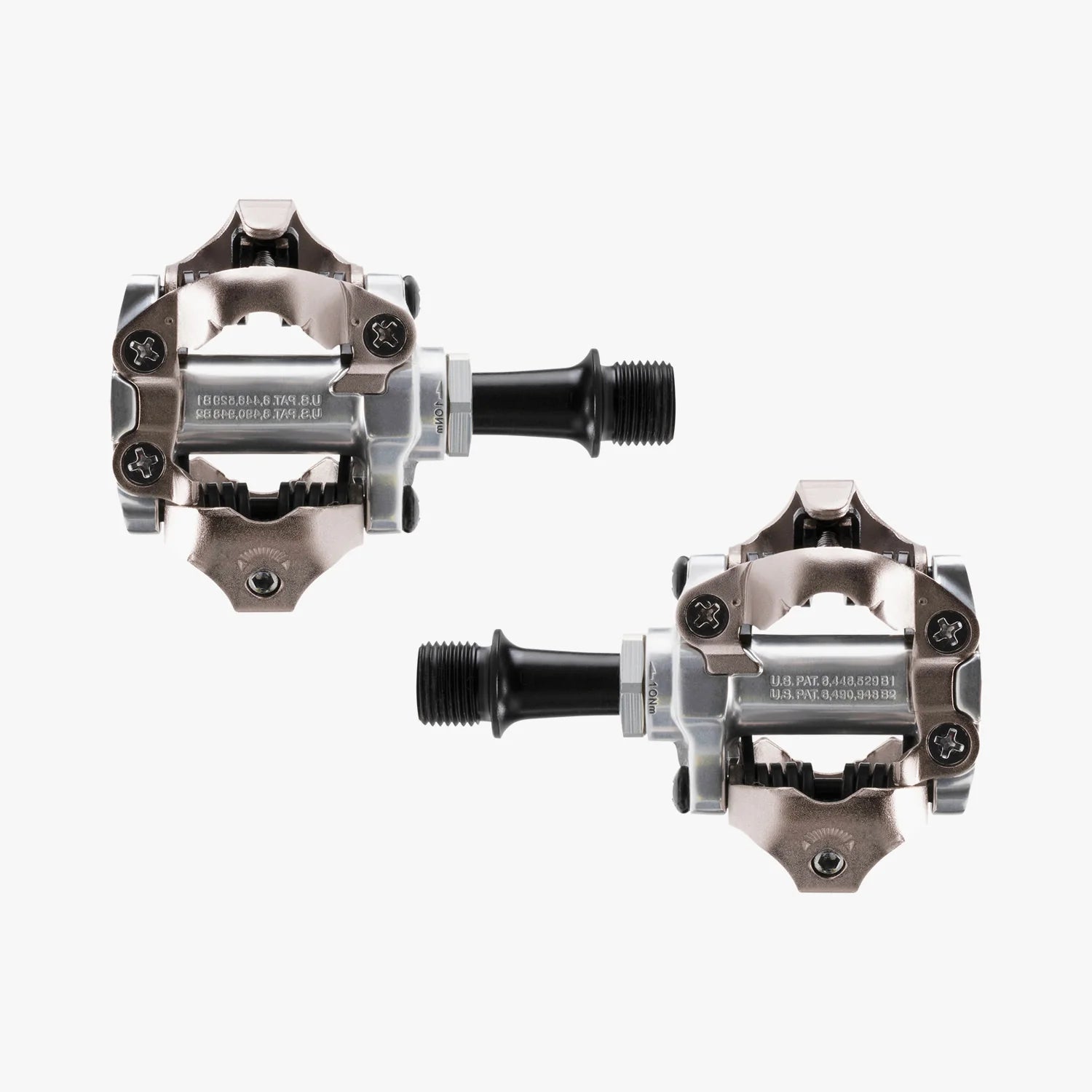 Pair of metallic bicycle pedals on a white background