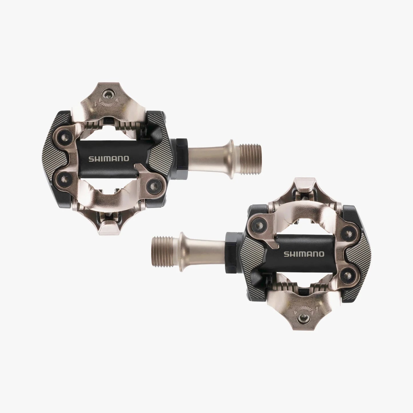 Two Shimano bicycle pedals on a white background