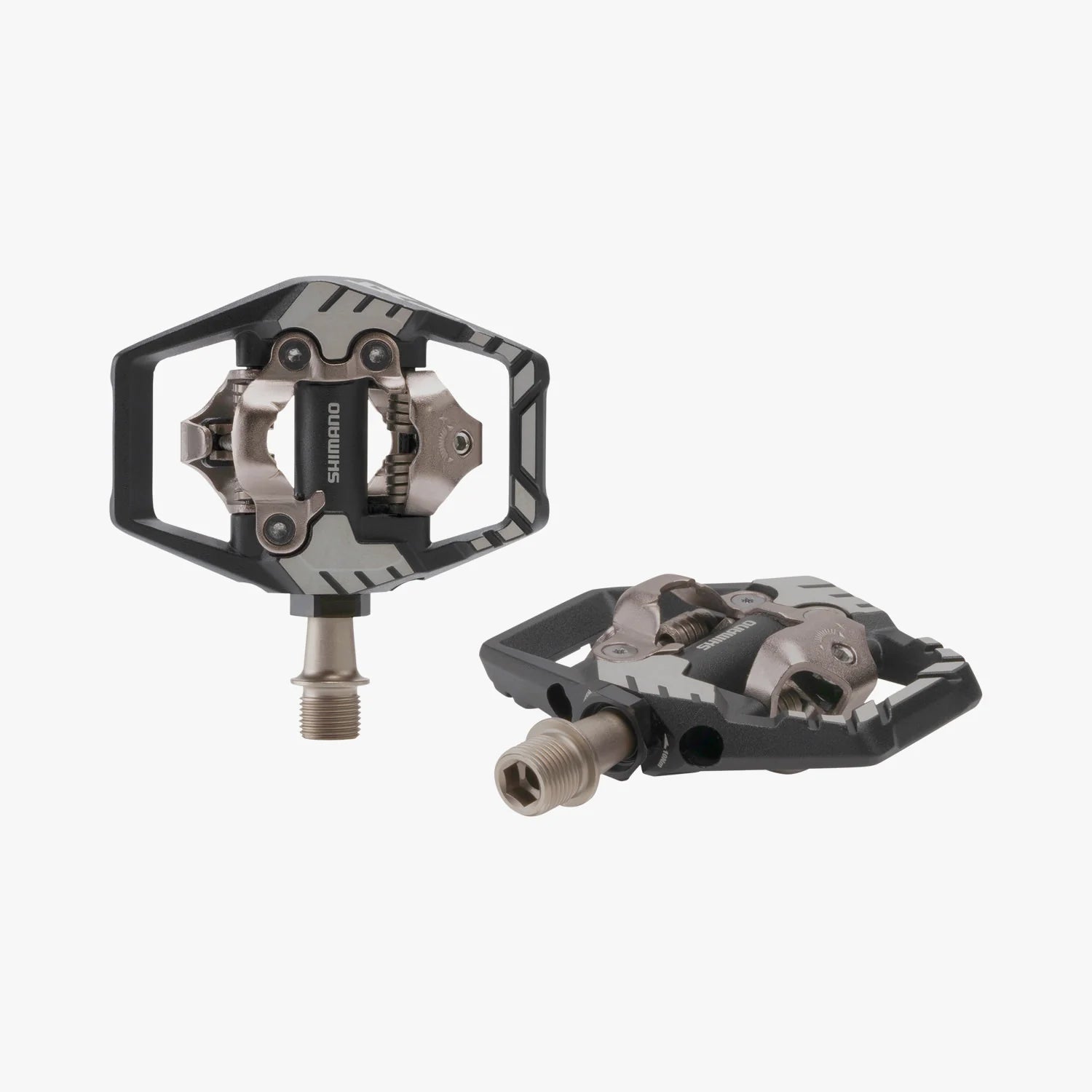 Pair of black and silver bicycle pedals on a white background