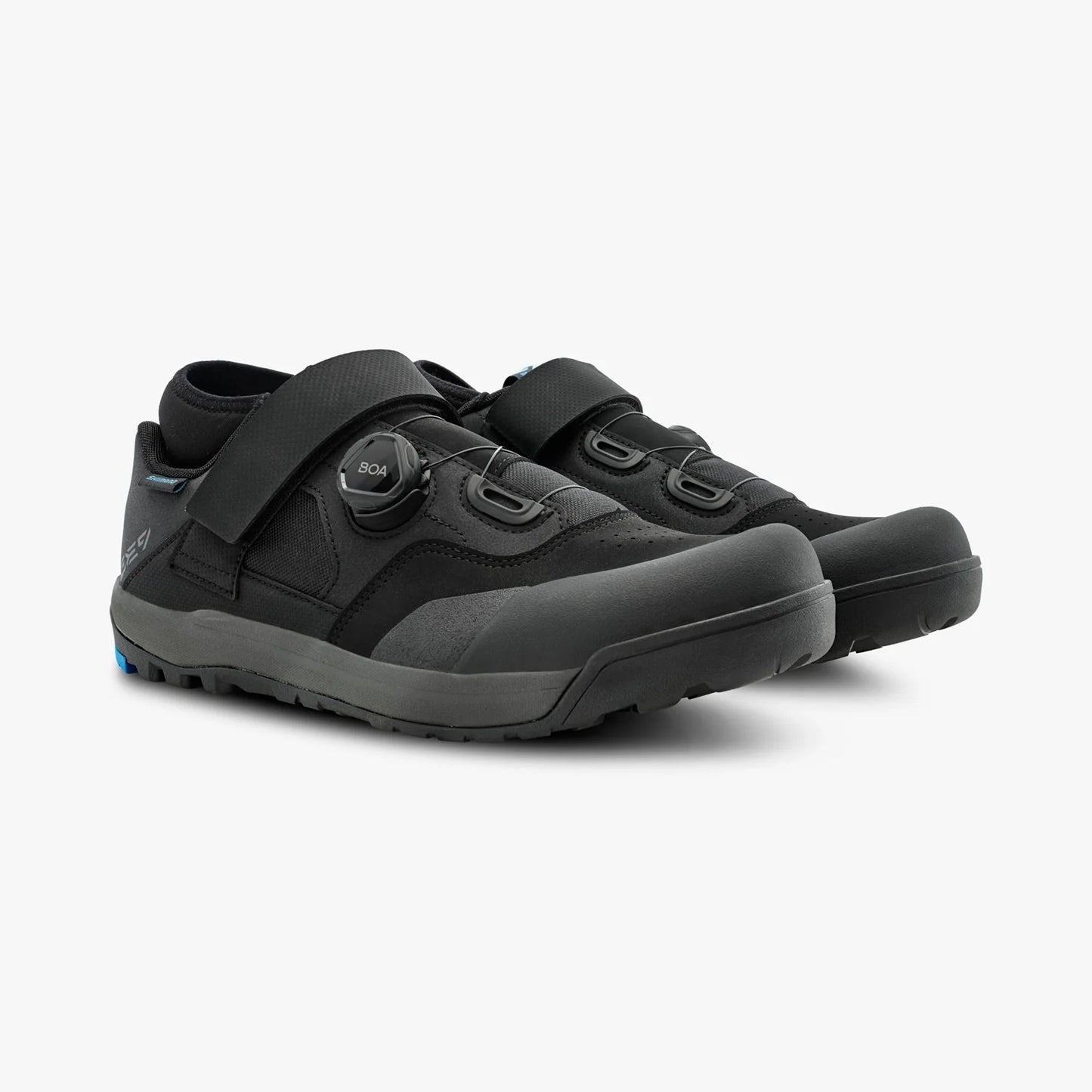 Pair of black shoes with velcro straps on a white background