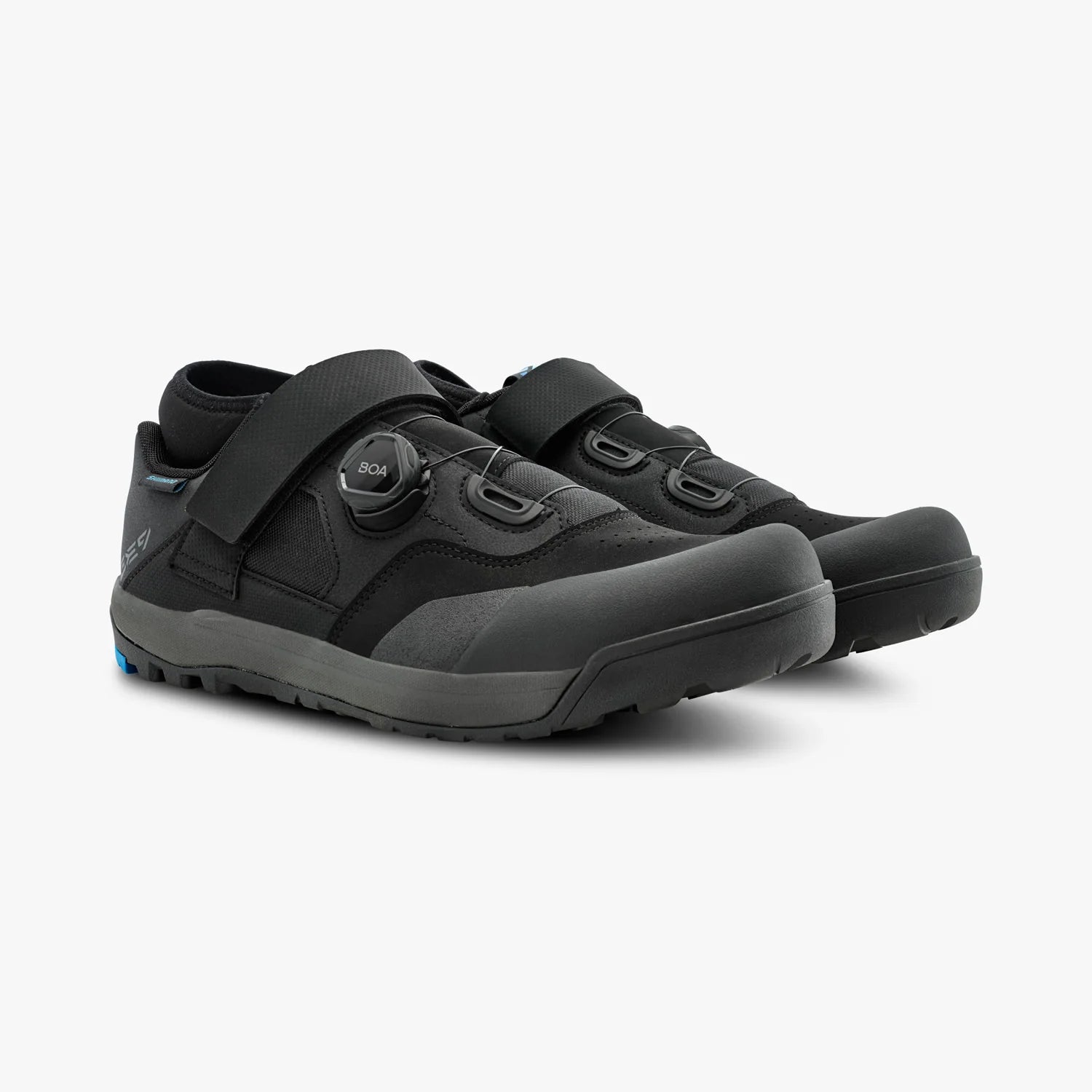 Pair of black shoes with velcro straps on a white background