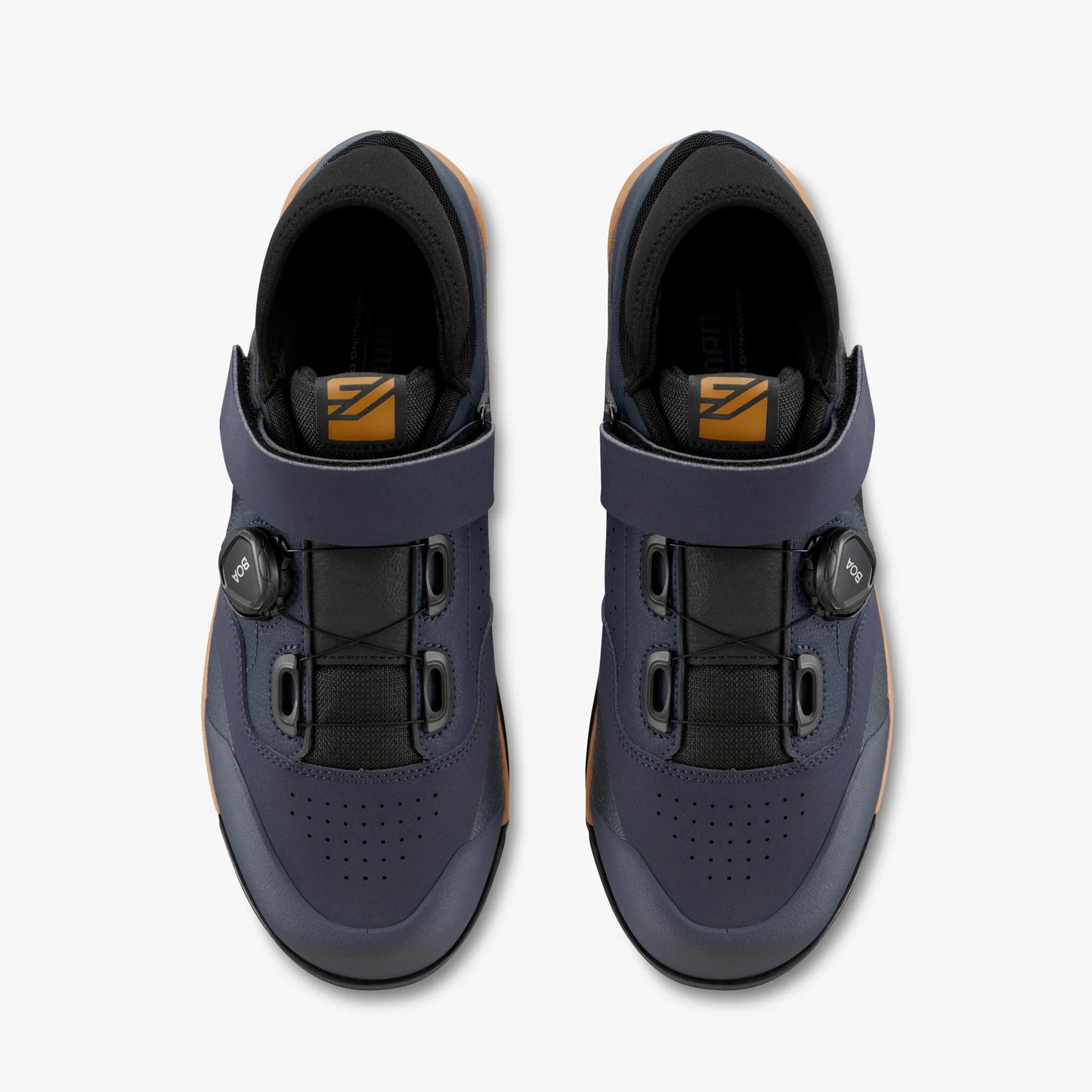 Pair of blue cycling shoes with black buckles on a white background