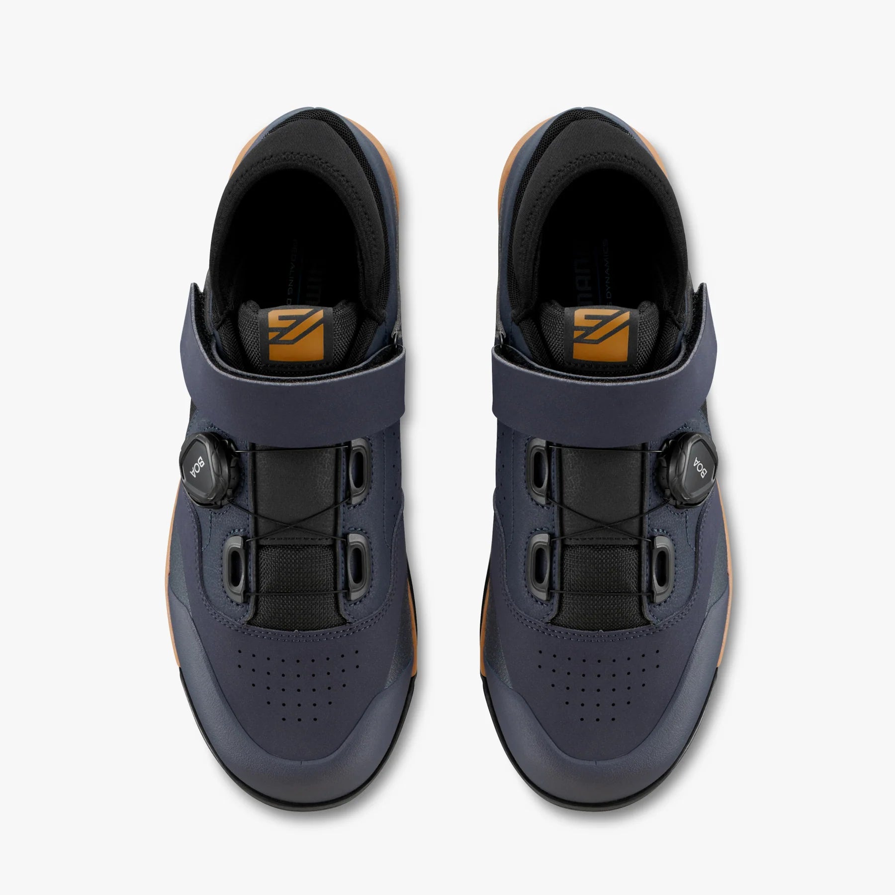 Pair of blue cycling shoes with black buckles on a white background