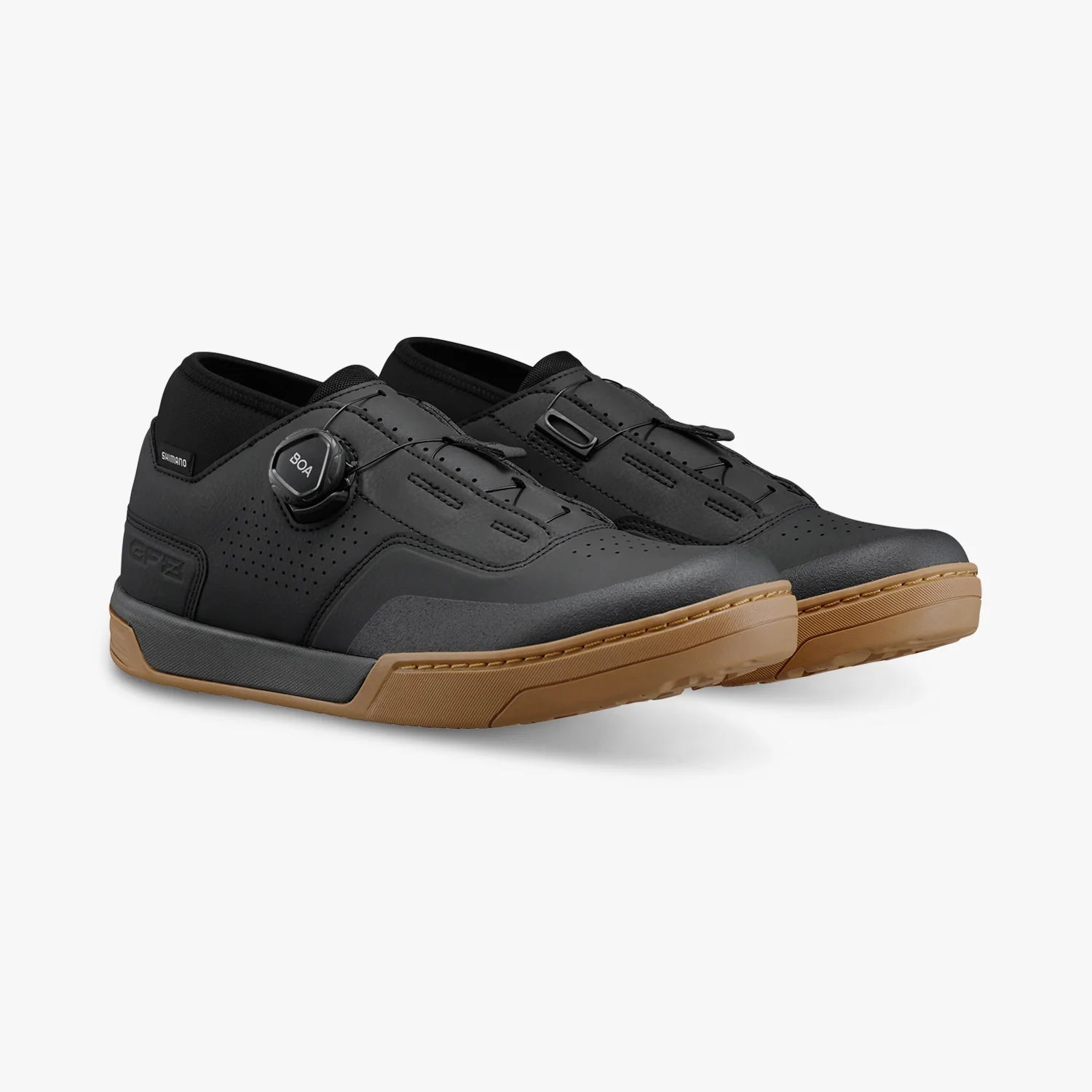 Black sneakers with brown soles on a white background