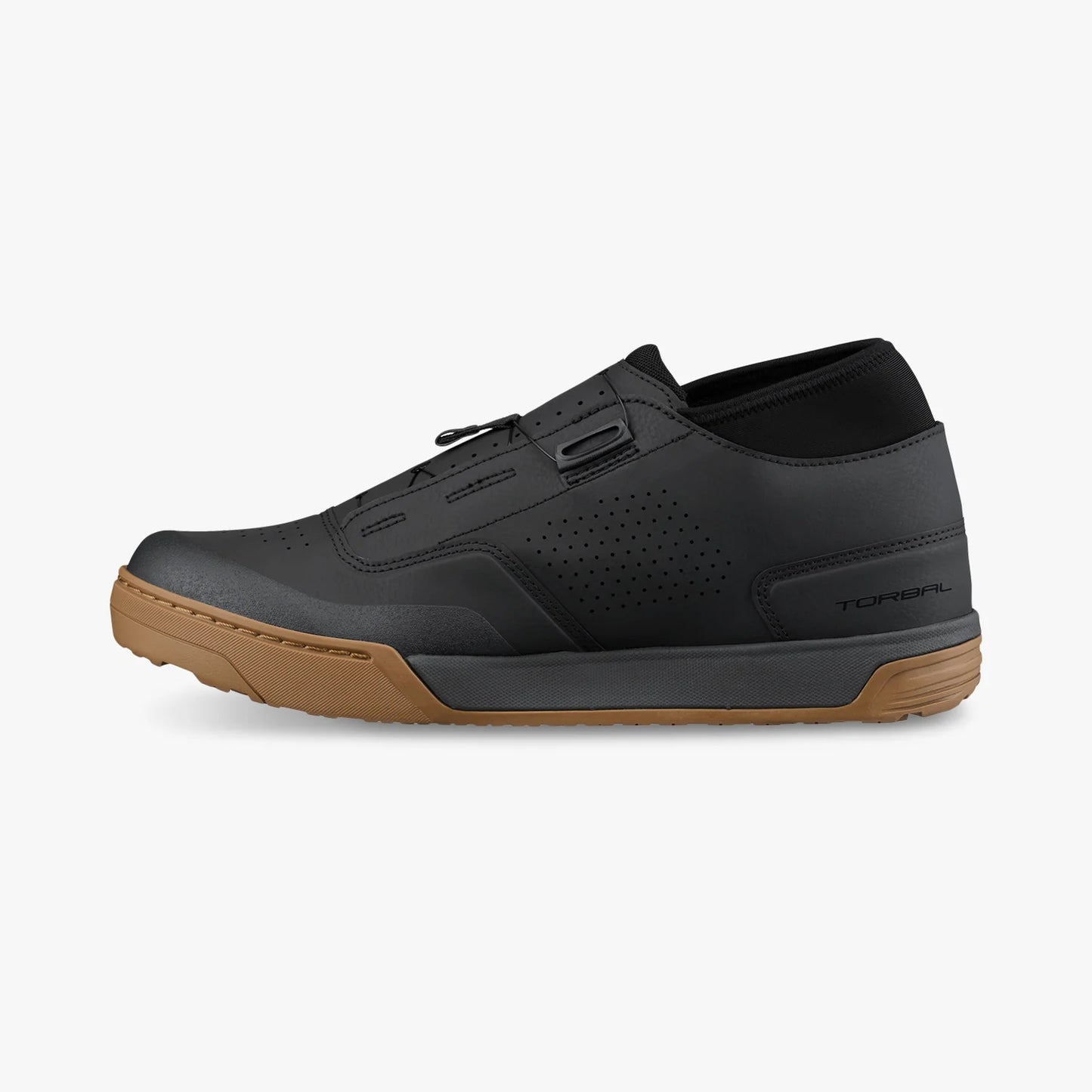 Black shoe with brown sole on a white background
