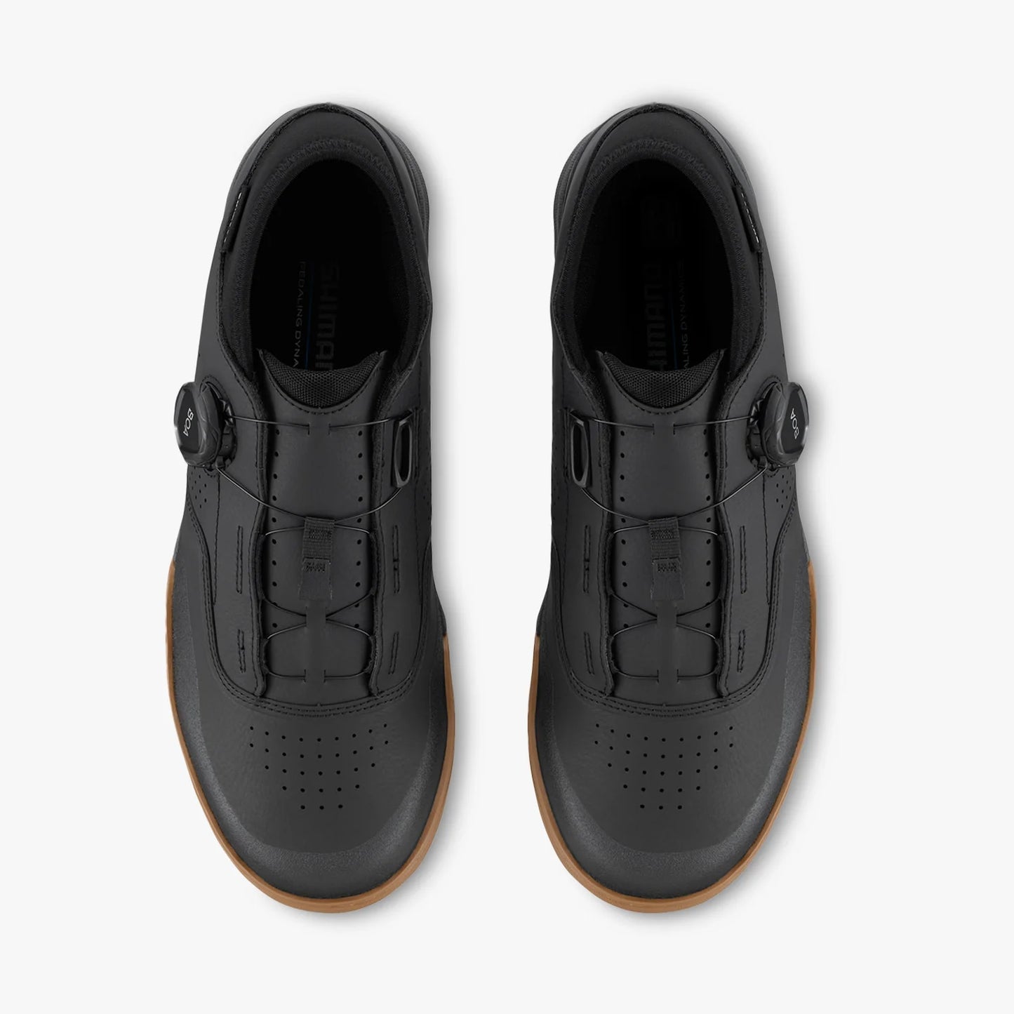 Black shoes with brown soles on a white background