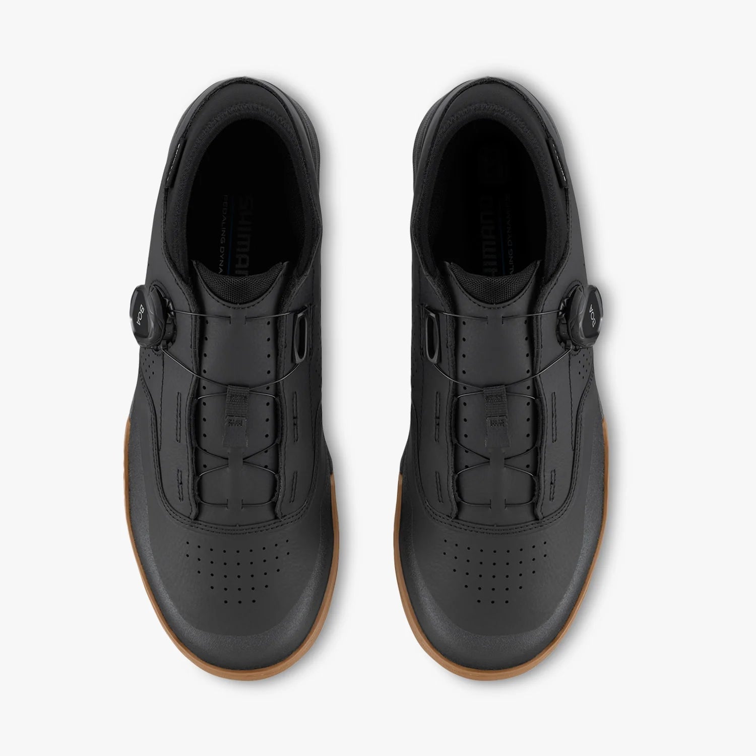 Black shoes with brown soles on a white background